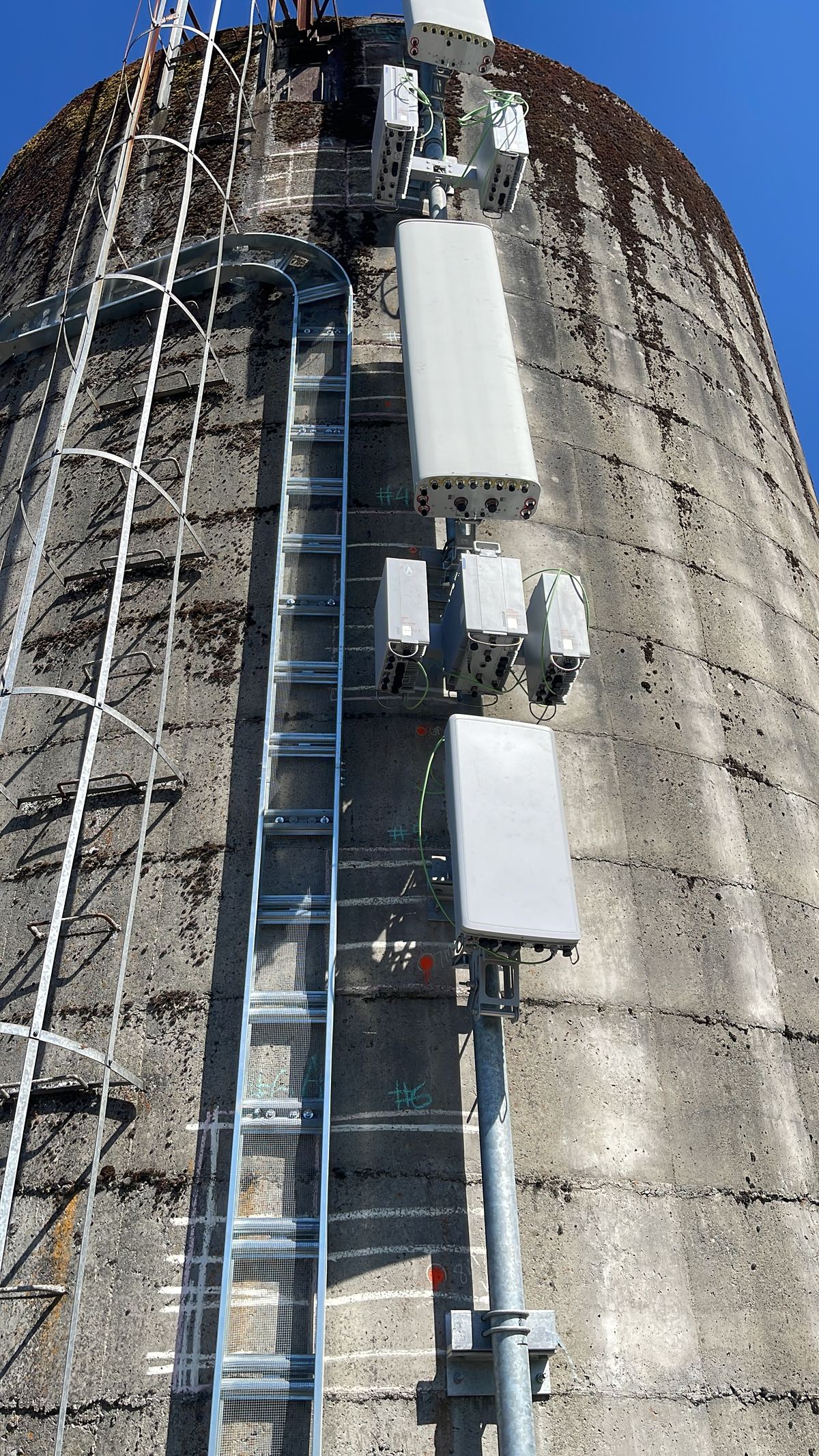 Close-up of panel antennas and RF equipment mounted on a tower structure