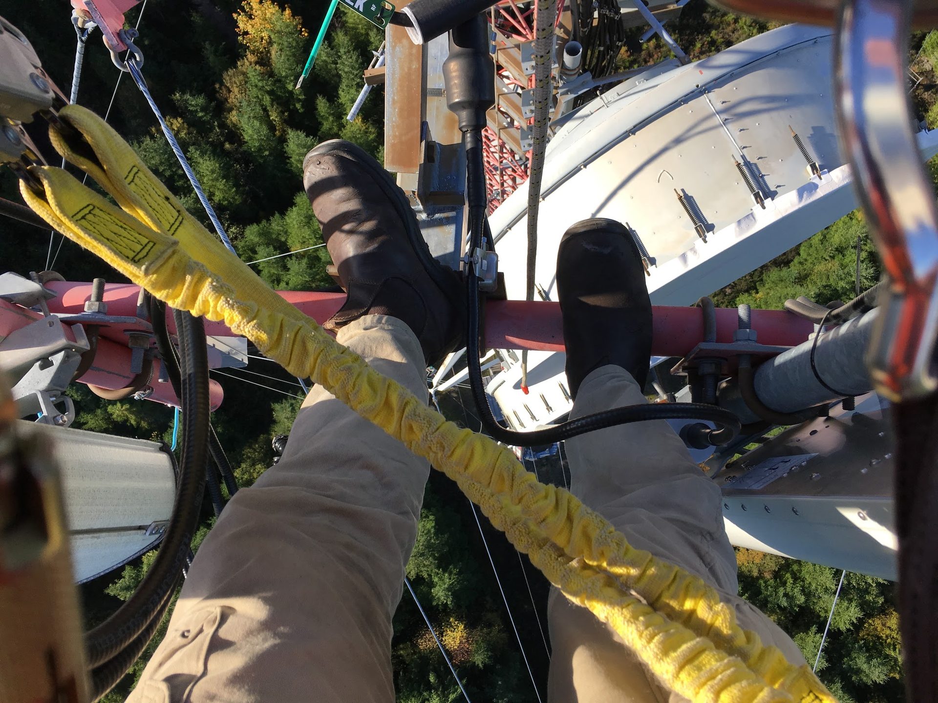 Tower climber's boots on a tower leg, high above the ground